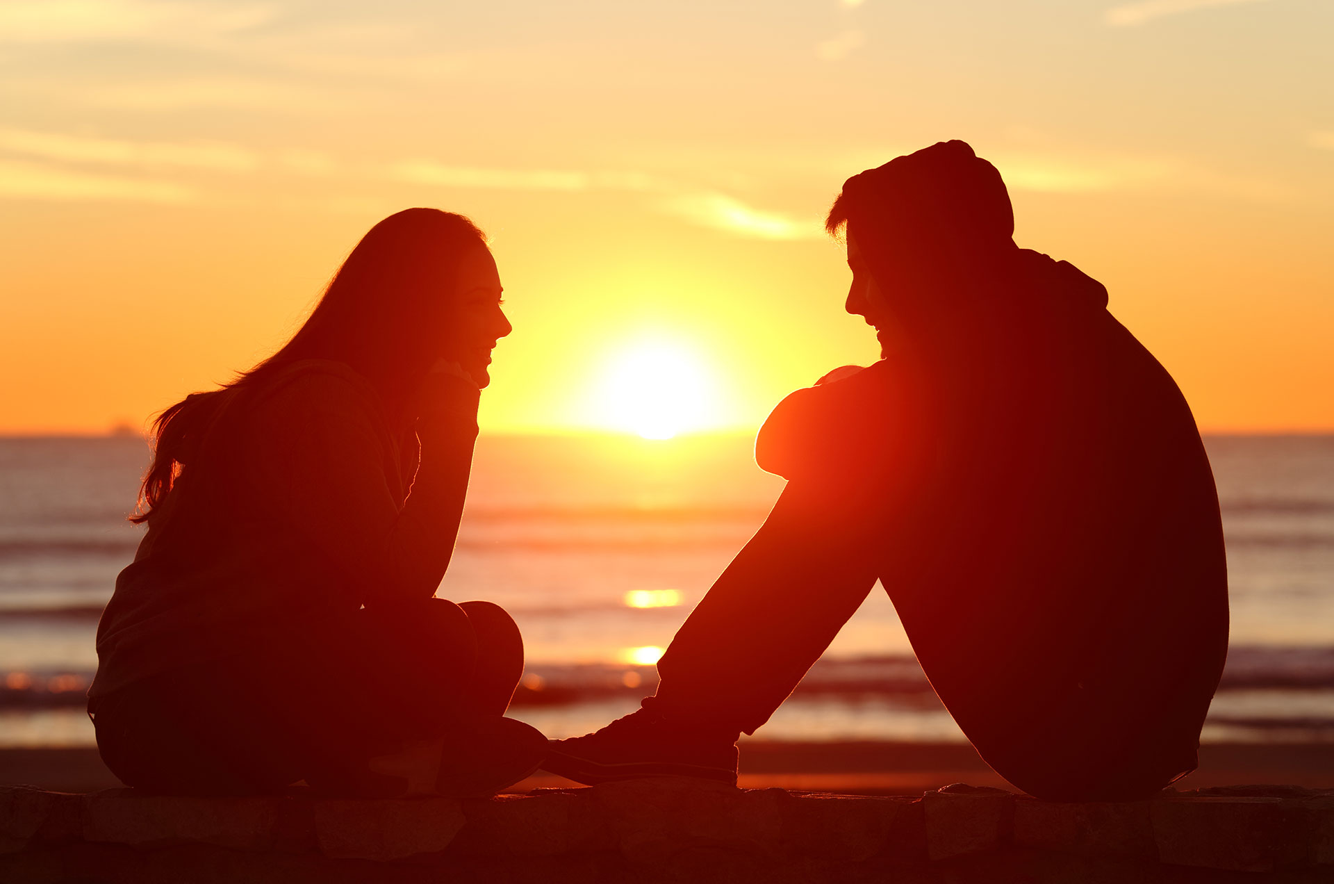 A Better You Blog, Importance of Communication in Relationships: Couple Sitting on the Beach Talking to Each Other
